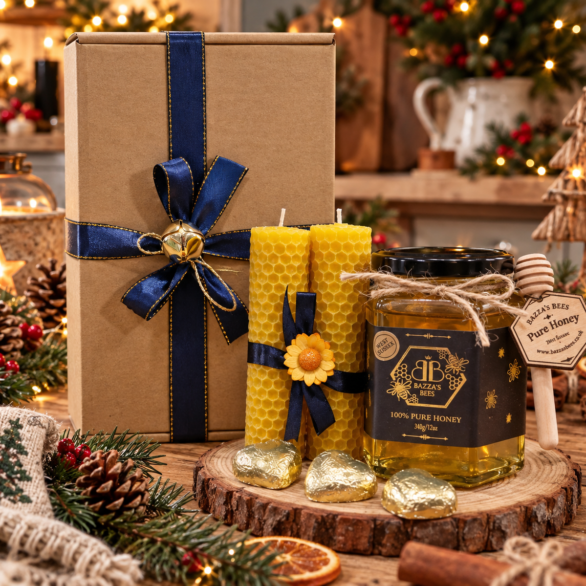A holiday gift set featuring a large brown kraft box with a navy ribbon, two yellow honey candles with navy ribbons and sunflower accents, and a jar of pure honey on a wooden slice with gold foil chocolates and a honey dipper, set against a festive Christmas background.